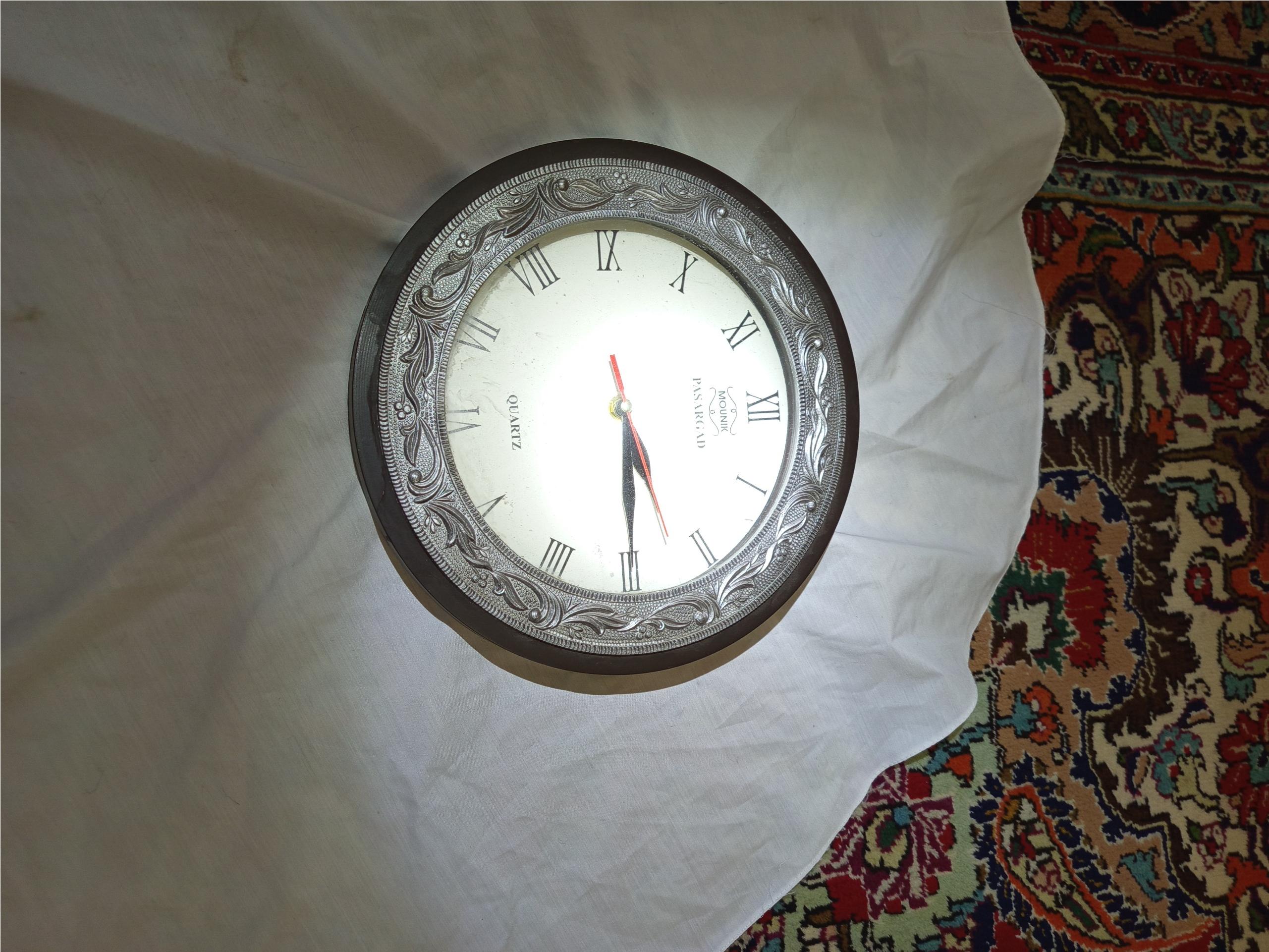 یک عدد ساعت دیواری که قسمت ساعت سالم